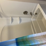 Tub shower unit that is being removed