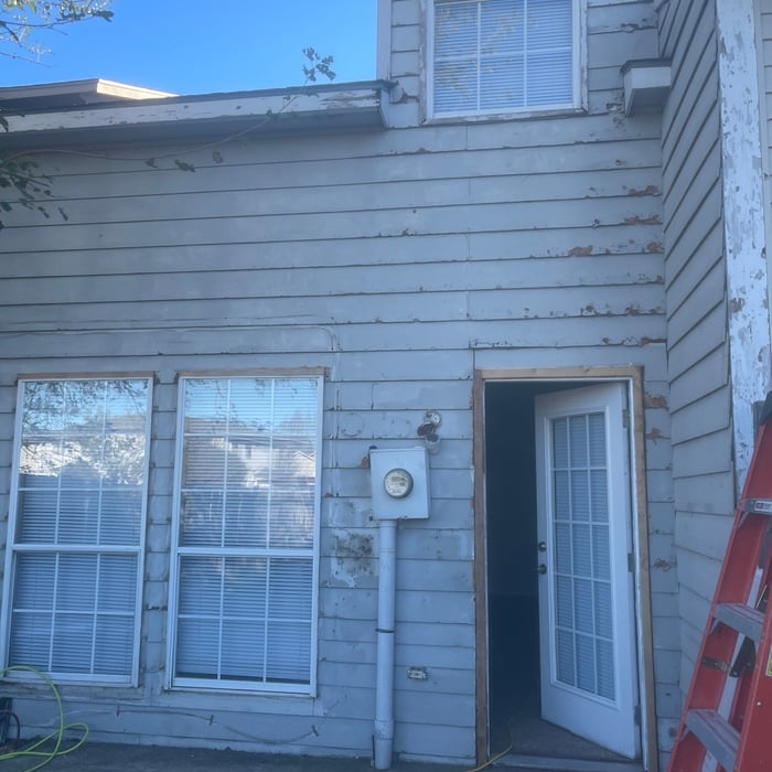 Before photo of damaged siding