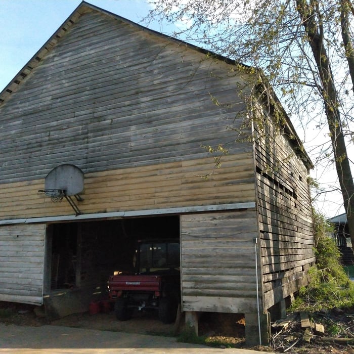Before view of deteriorating siding and piers