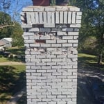 Damaged bricks on chimney stack