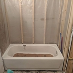 Set tub and level in mortar bed