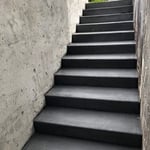 black broomed steps to basement and retaining wall
