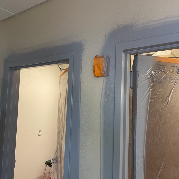 Spray paint metal door frames.