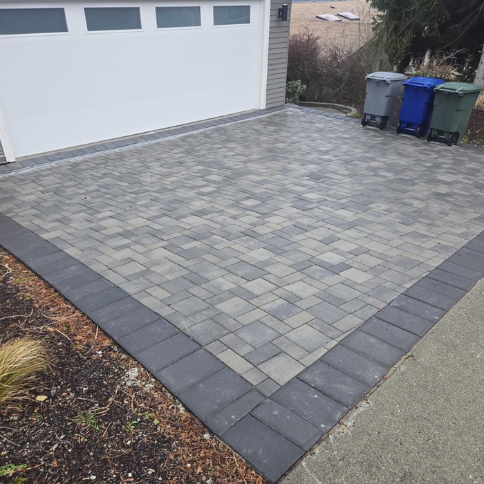 Complete driveway transformation in Redmond, WA. Seattle Build removed the existing cracked and deteriorating concrete driveway and replaced it with a professionally installed paver driveway built for long-term durability. The project included demolition, excavation, proper base preparation, grading, drainage improvements, compaction, and paver installation. Special attention was given to water management and drainage to help prevent pooling and protect the driveway over time. The finished paver