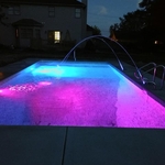 Pool with lights on and deck jets