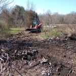Burn pile finally getting moved