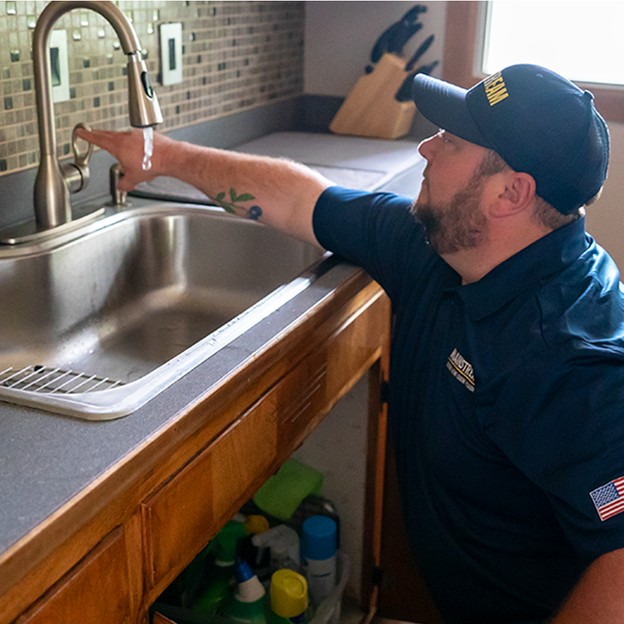 Tech working on sink