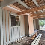Progress photos of siding repair and deck beams