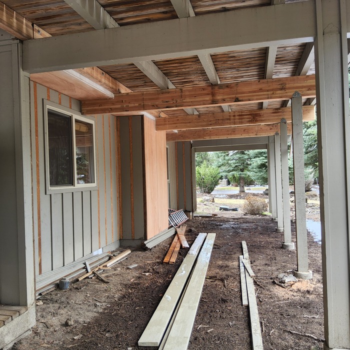 Progress photos of siding repair and deck beams
