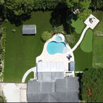 Paradise - Backyard features around the luxurious swimming pool and travertine deck 2 Putting Greens and lush artificial grass lawn with mounds and rolling hills.