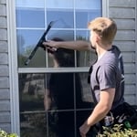 Me hand cleaning a window