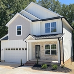 Installed metal roof, siding and black 5in gutters