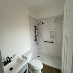Walk-In shower, toilet, vanity.