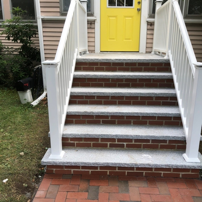 Brick and granite stone. PVC handrail.