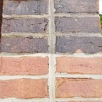 Brick neighborhood sign being cleaned