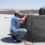 Bishop Air Service technician repairing an AC unit.