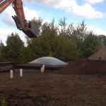 Picture removing dirt off of a earth home to resea