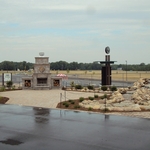 Brick Paver Patio, Outdoor Fireplace, Pondless Waterfall, and Associated Landscape Plantings