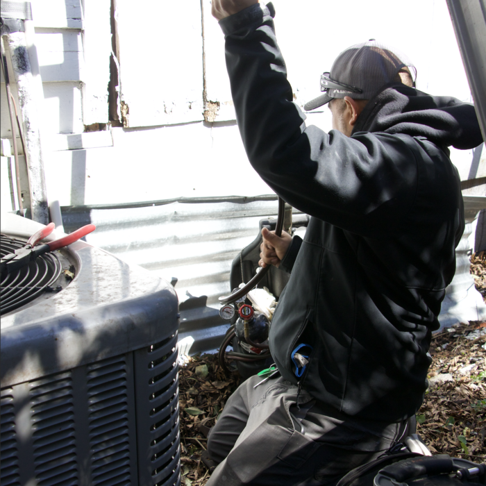 Our Green Dot HVAC technician performing a repair on an AC unit. Wilmington summers are no joke. We make sure every home stays cool and comfortable, no matter the heat!