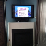 TV mounted in corner.