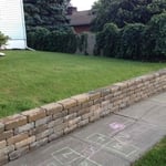 Removed existing railroad tie retaining wall and install EP Henry retaining wall block.