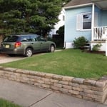 Removed existing railroad tie retaining wall and install EP Henry retaining wall block.