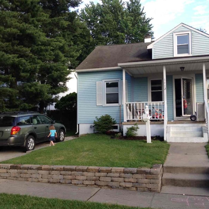 Remove stone/grass driveway and install single car concrete driveway.