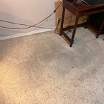 Dirty area under computer desk.