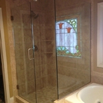 Frameless shower enclosure