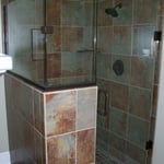 Frameless shower door and enclosure