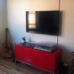 flat screen hung on the wall on a tilting bracket and concealed wires.
