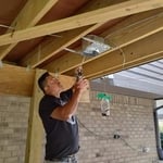Installing recessed cans for exterior lighting.