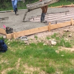 Pouring concrete for driveway.