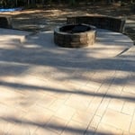Stamped concrete patio, with sitting walls and fire pit.