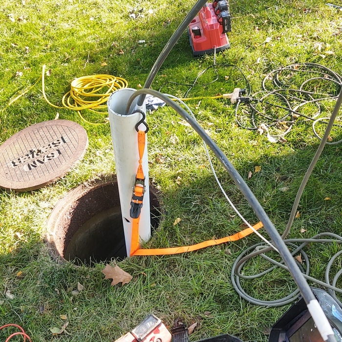 Inserting the patch material into the sewer line from point of access