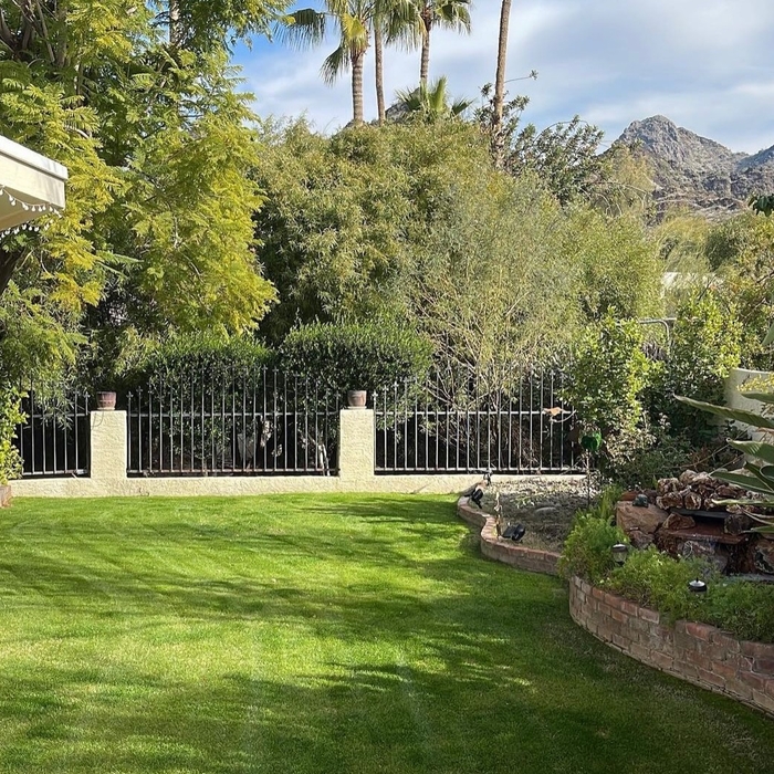Desert coral enjoys going the extra mile to guarantee a lush green lawn for this beautiful property.