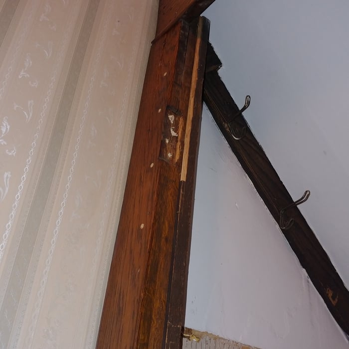 Three section door jam with integrity loss due to weight of bowed solid wood door.