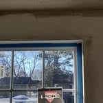 Fixed cracks above windows and around windowsill textured and painted