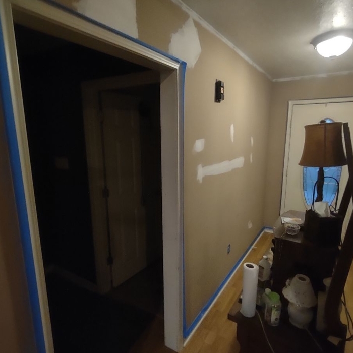 All cracks in entryway and above doors repaired textured and painted