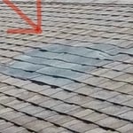 Damaged shingles found during a roof inspection.