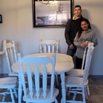 Is me and my wife standing by the furniture is furniture the dining room set that I just painted over 3 days had fun doing it and had A-blast and enjoying helping some client make a big difference in her life