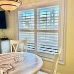 Clear view custom plantation shutters in dining room.