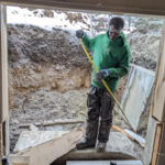 Then using a concrete saw they cut through the basement wall.