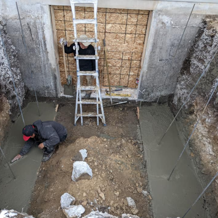 Poured the footing. As you can see the 4 inch rebar, is for preparation to form the retaining wall.