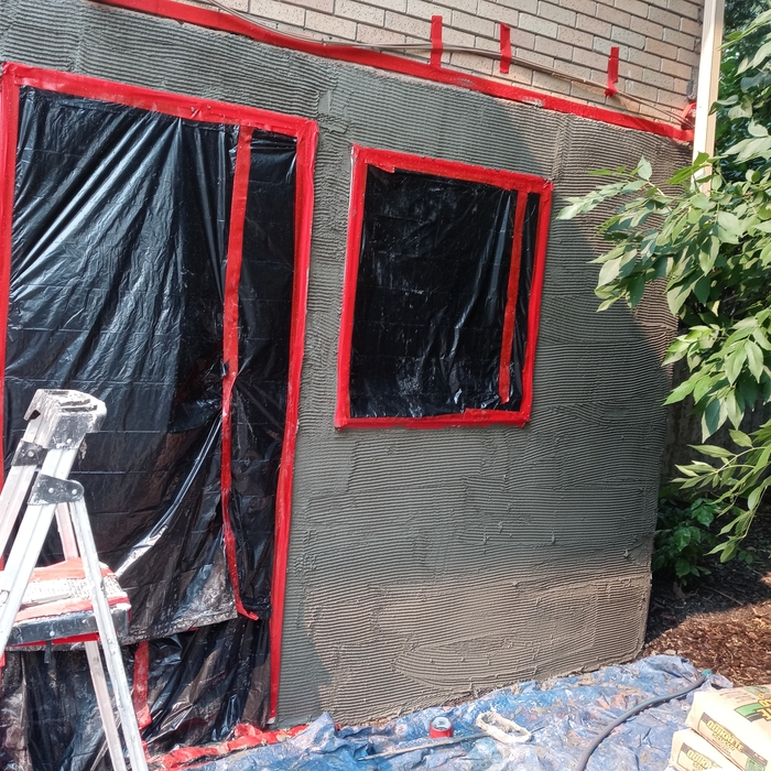 Scratch coat for conventional stucco