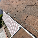 Gutters have some sand from the Asphalt shingles