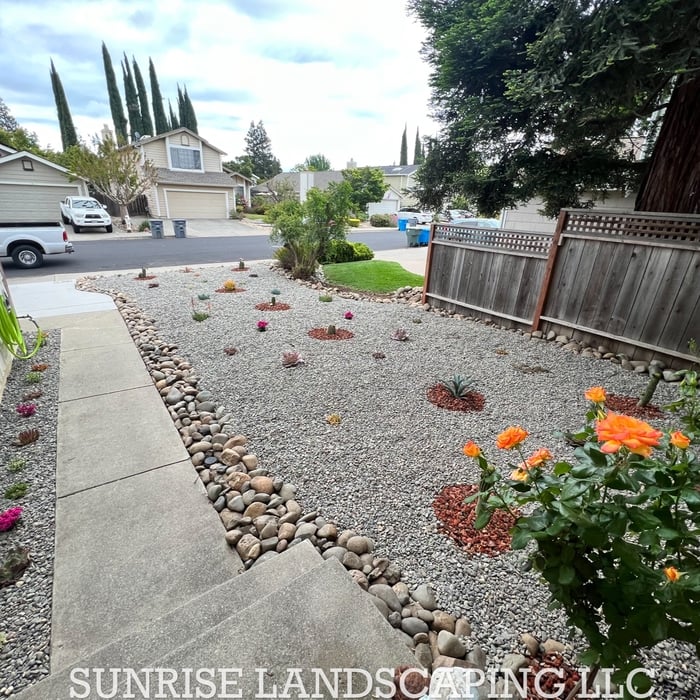 Removal of old grass and river rock installation