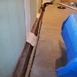 Foundation perimeter waterproofing system with sump pump and wall crack coverings.