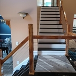 Resurfaced staircase: risers and baseboards white, treads stained and sealed in black.