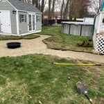 preparing for installation of paver walkways surrounding a circle firepit